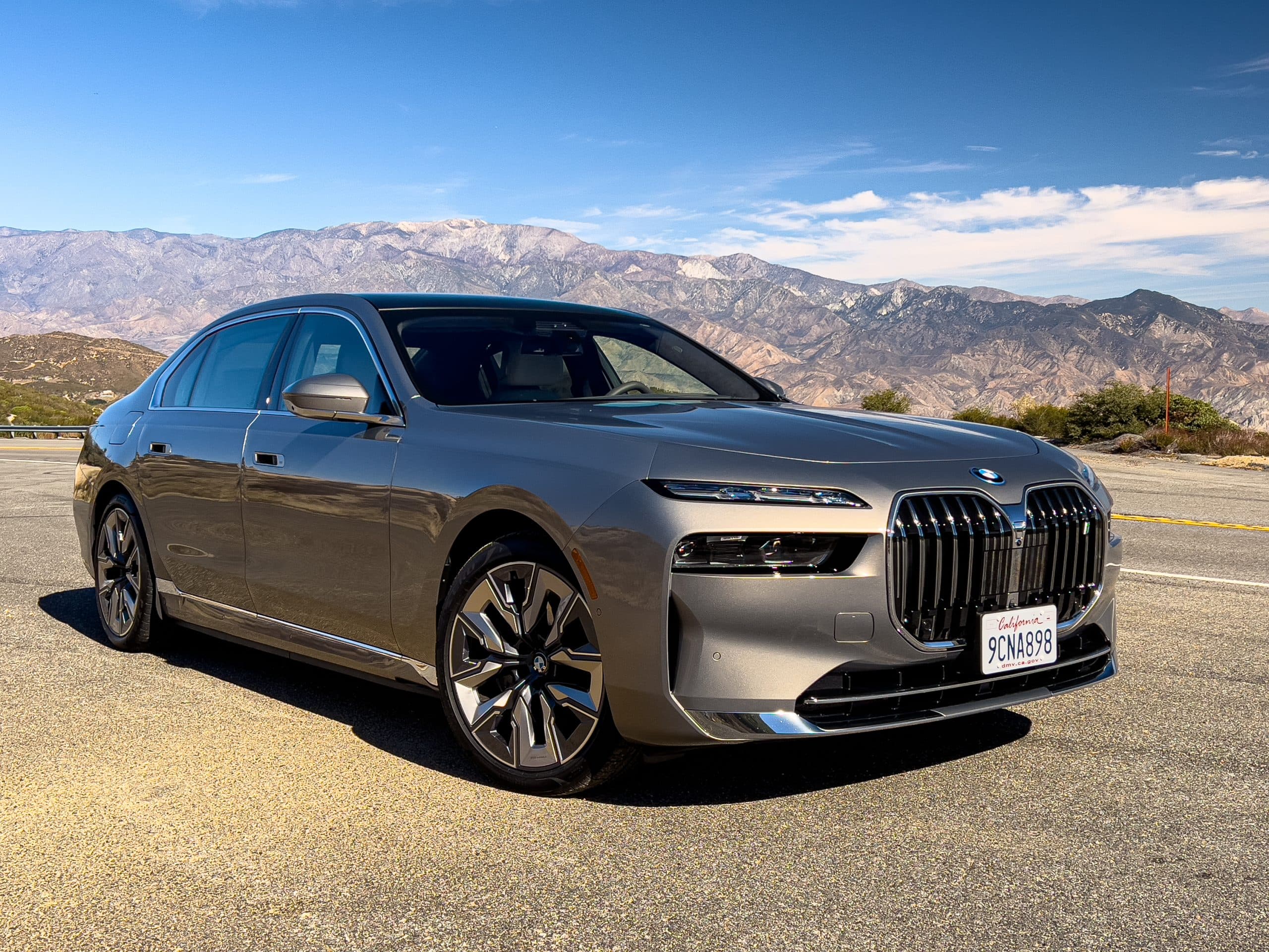 Luxury sedan driving through a mountain road